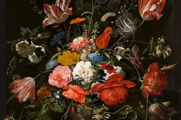 This image depicts a detailed and colorful bouquet of various flowers in a vase set against a dark background.