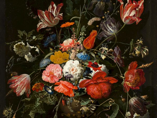 This image depicts a detailed and colorful bouquet of various flowers in a vase set against a dark background.